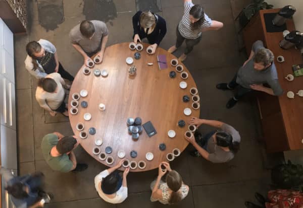 people standing around a cupping table