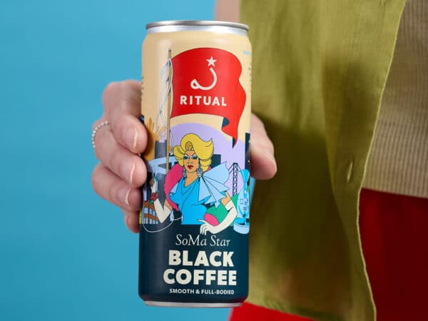 Hand holding a can of SoMa Star black coffee